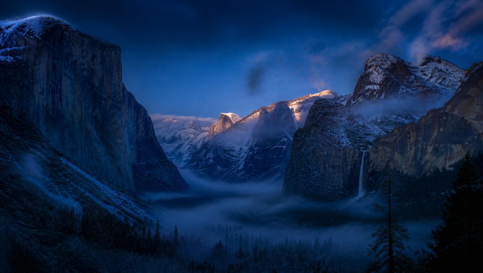 Deep blue mountain valley at dusk